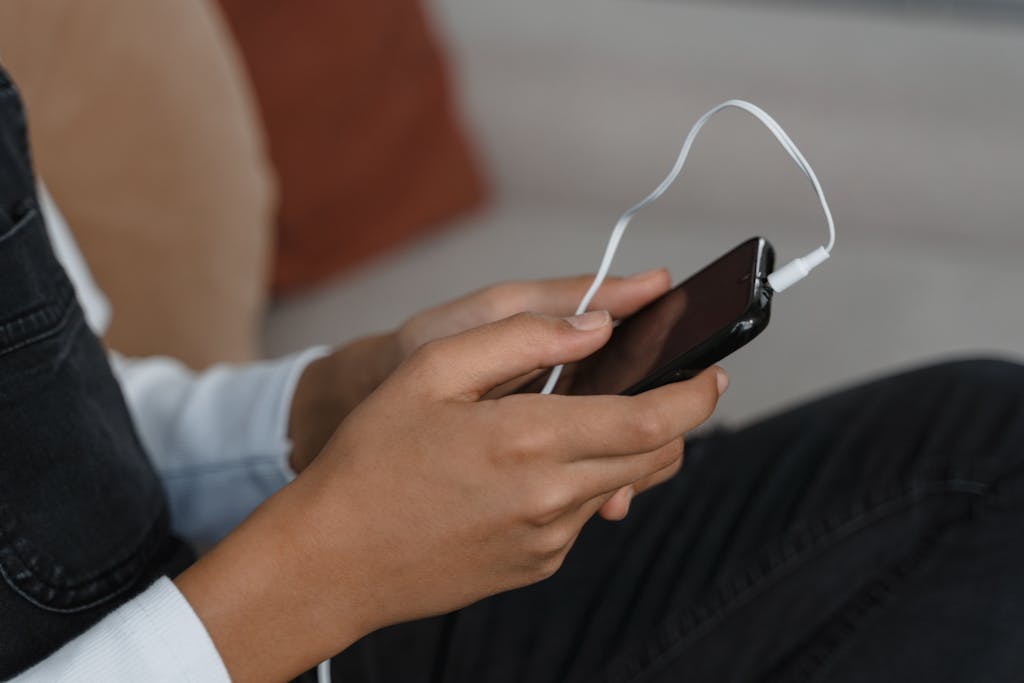 Photo of Person holding a Black Phone